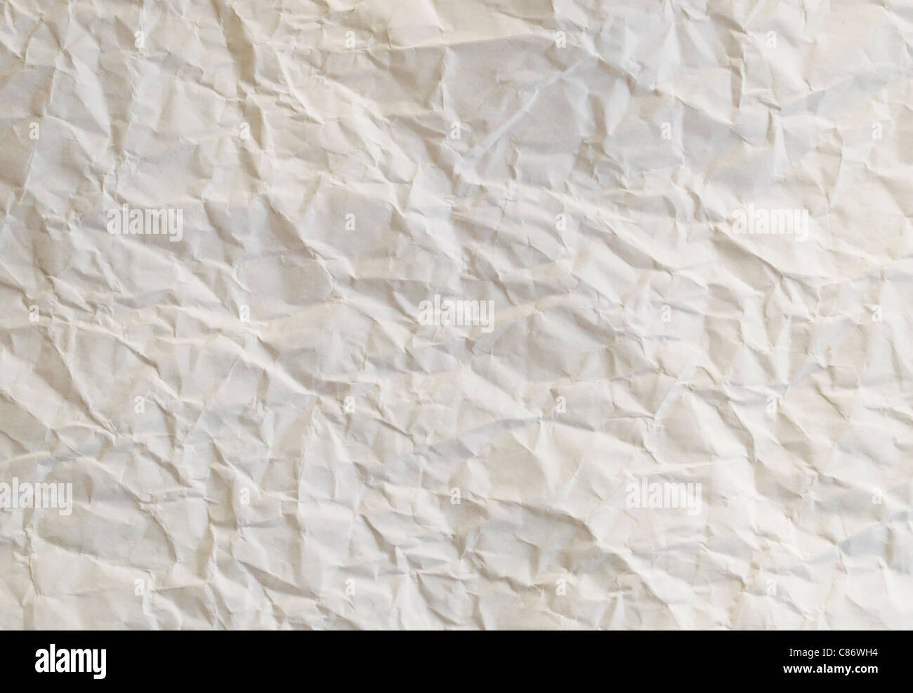 Crumpled cream paper texture effect, abstract background Stock Photo