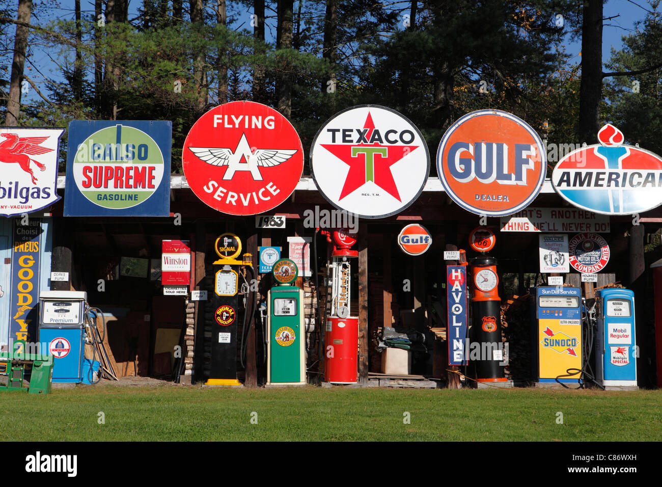 Classic filling station signs, logos and pumps on display by a collector in New Hampshire, USA Stock Photo