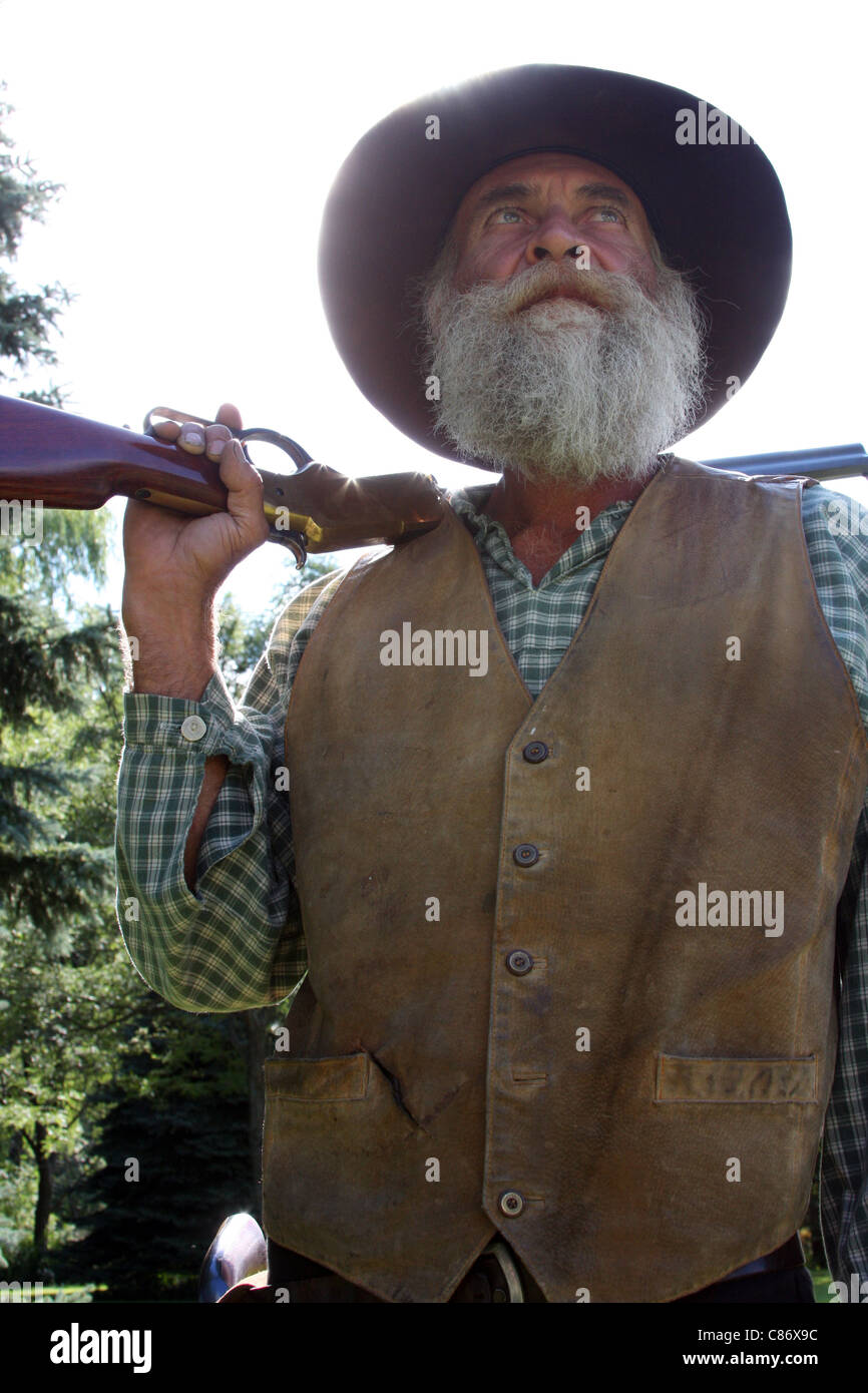 A cowboy with a rifle Stock Photo - Alamy