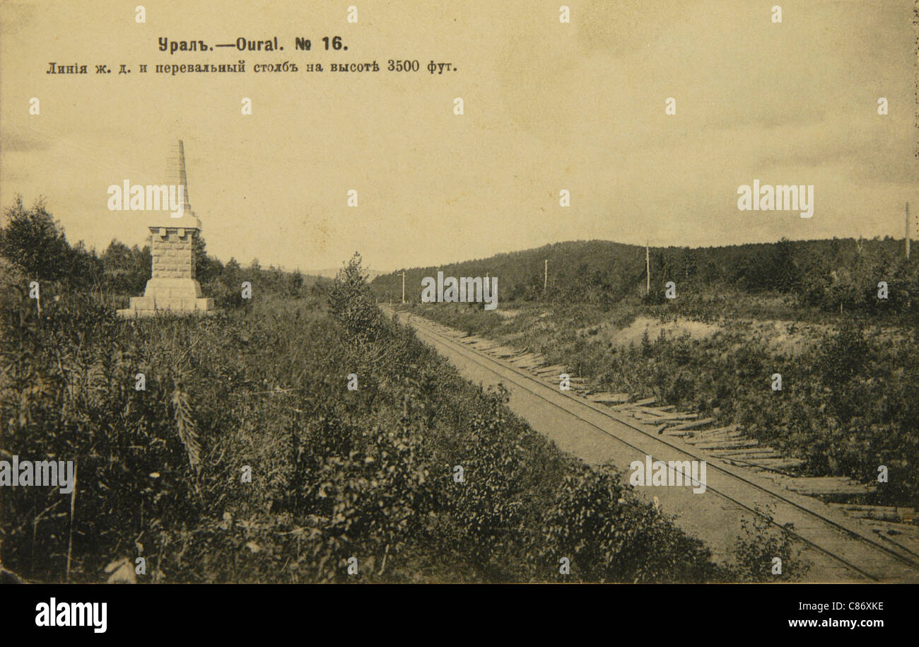 Trans-Siberian Railway and the obelisk on the border between Europe and Asia near Zlatoust in the Ural Mountains, Russian Empire. Black and white vintage photograph by Russian photographer Veniamin Metenkov dated from the beginning of the 20th century issued in the Russian vintage postcard published by Veniamin Metenkov himself in Yekaterinburg. Text in Russian: Railroad and the mountain pass pillar at 3,500 feed. Courtesy of the Azoor Postcard Collection. Stock Photo