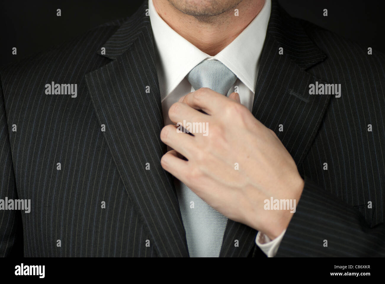 Adjusting the tie hi-res stock photography and images - Alamy