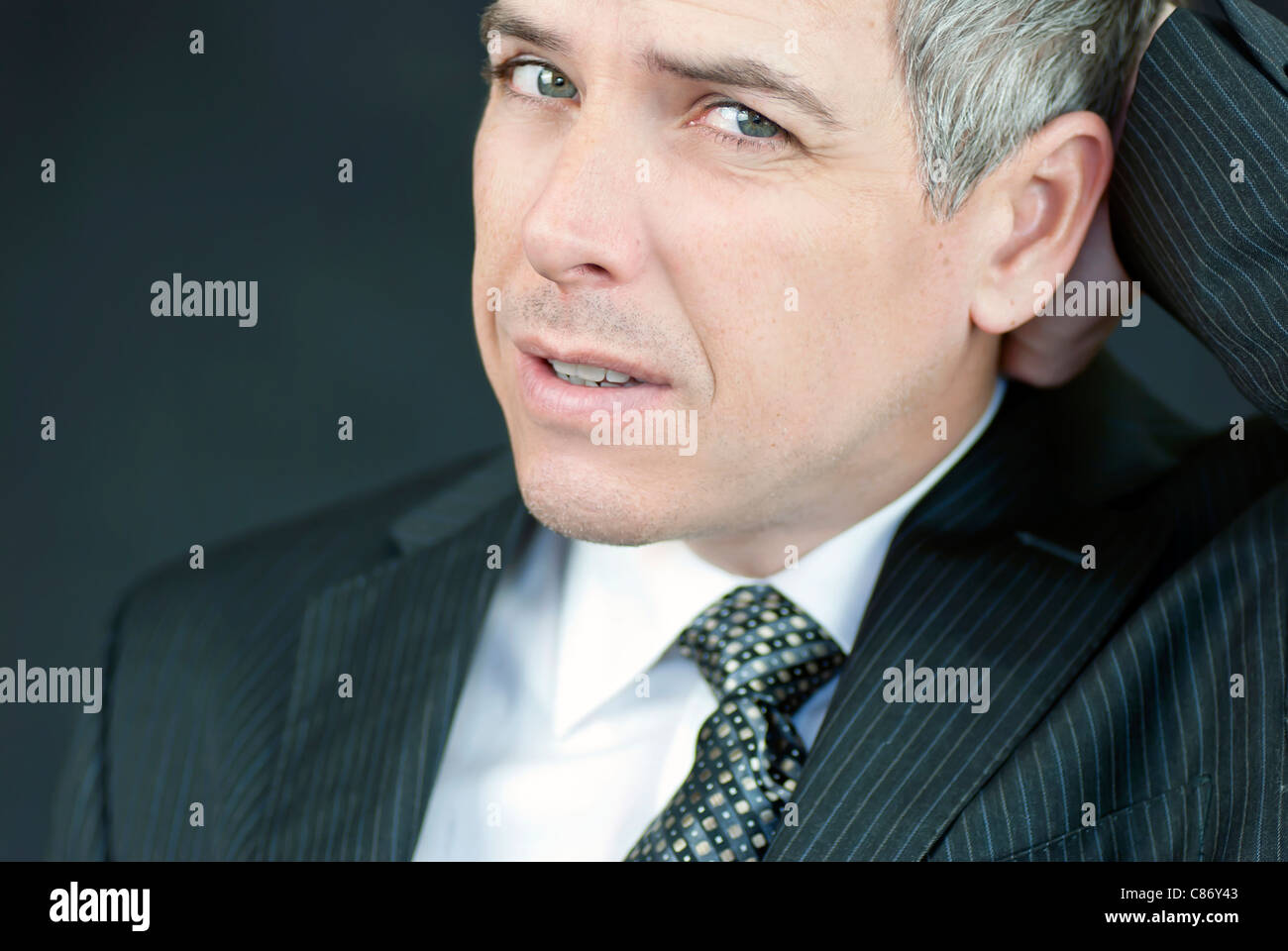 Close-up of a stressed businessman looking to camera. Stock Photo