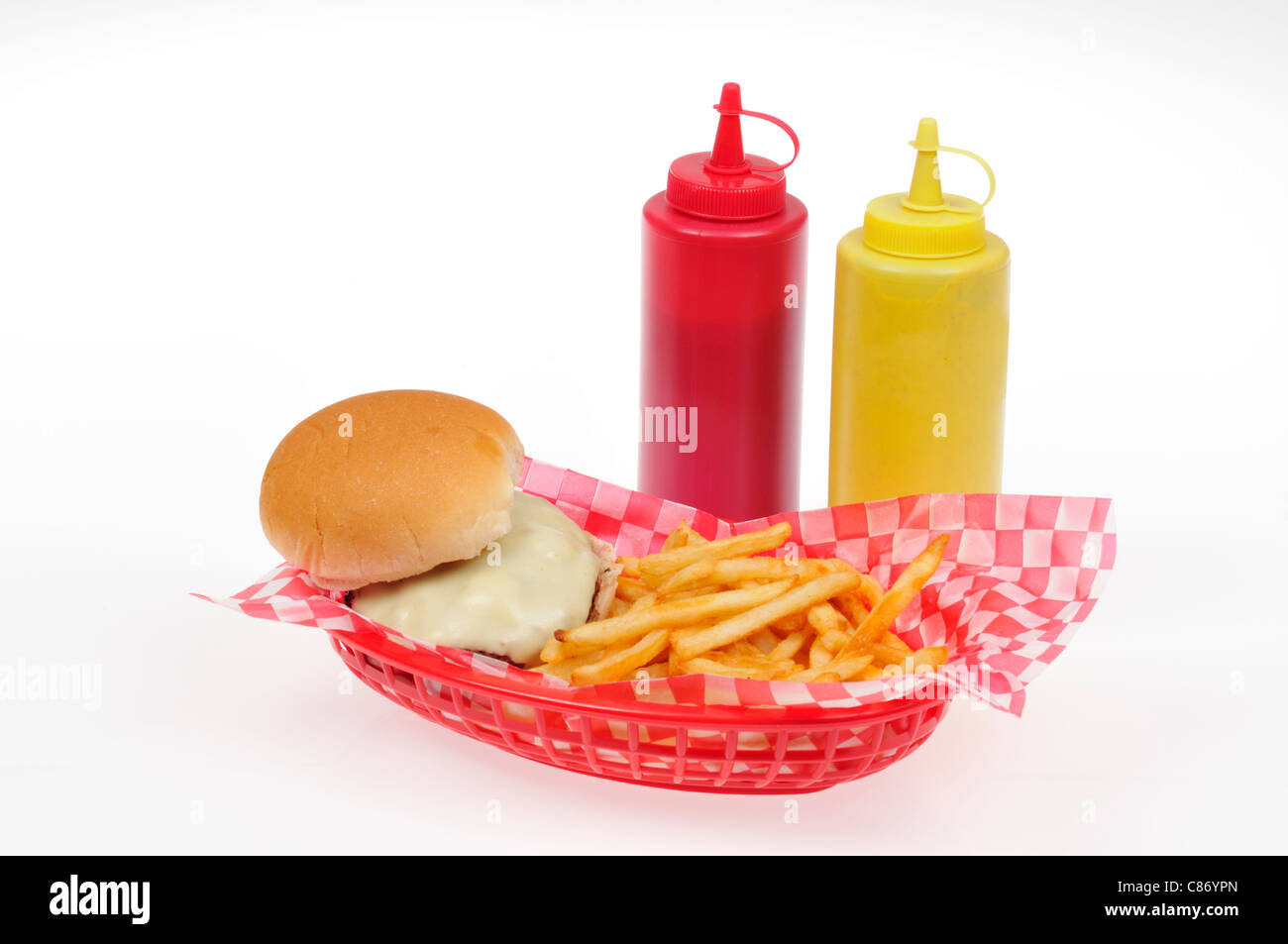 Cheeseburger with french fries in a red plastic retro basket with mustard and ketchup condiments on white background cutout. Stock Photo