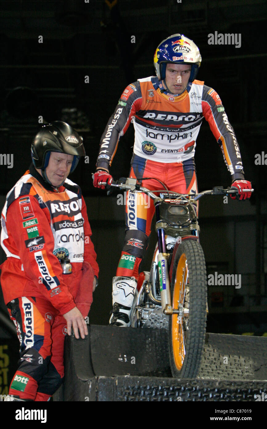 Dougie Lampkin MBE from Great Britain with helper in action on his Montesa bike at the Belfast round of the Indoor Trial World Championship, won by Adam Raga from Spain. Stock Photo
