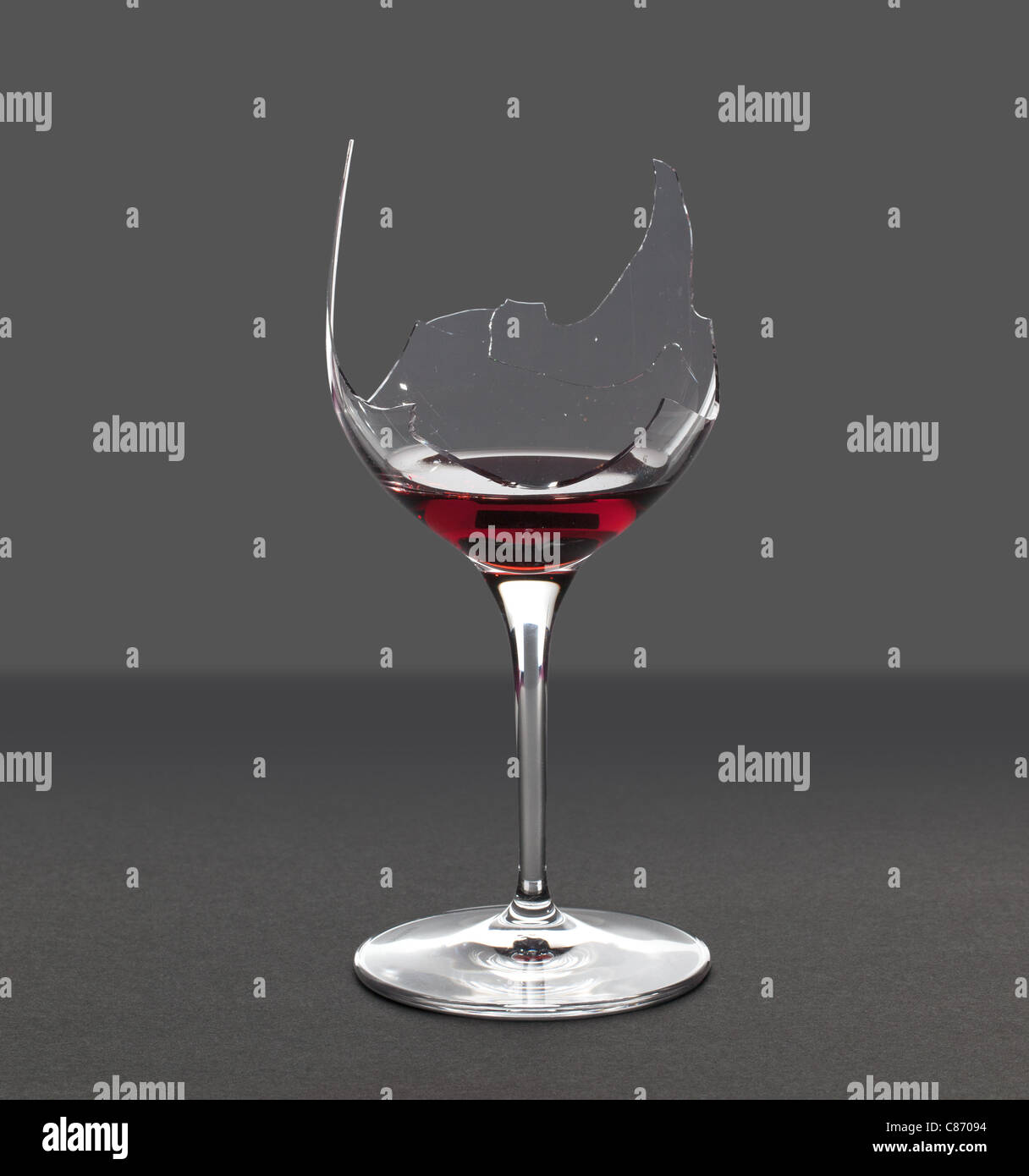 Red wine in a broken wine glass with an extraction path saved in the