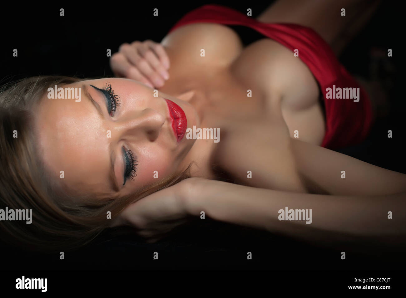 Sexy woman with big boobs lying on her back Stock Photo - Alamy