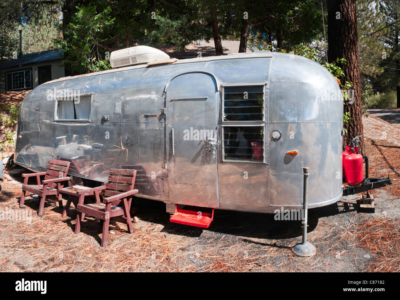 Airstream trailer with lawn chairs Stock Photo Alamy