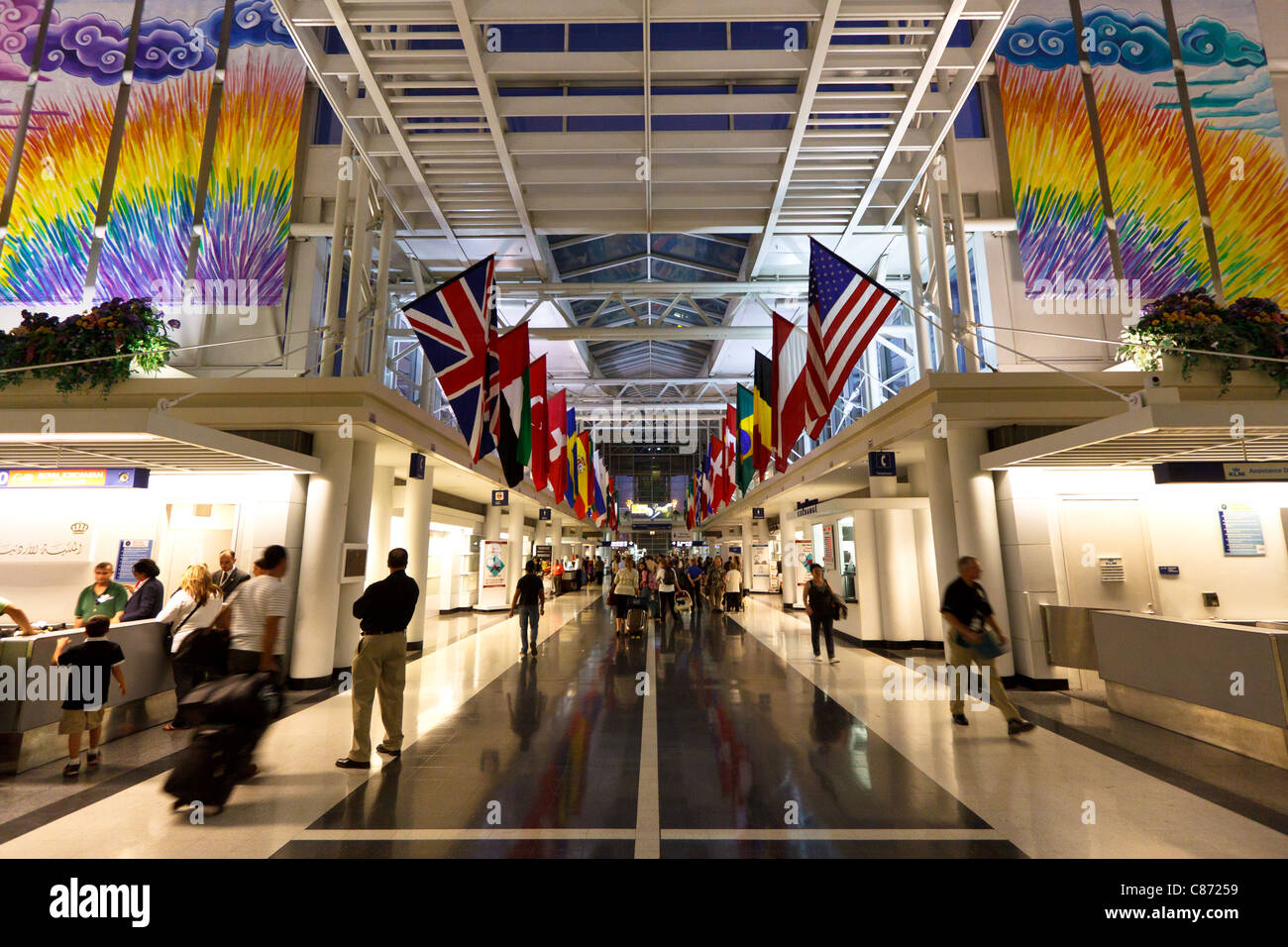 View inside O'Hare International Airport Terminal 5 showing the flags of different countries - Chicago, IL Stock Photo - Alamy