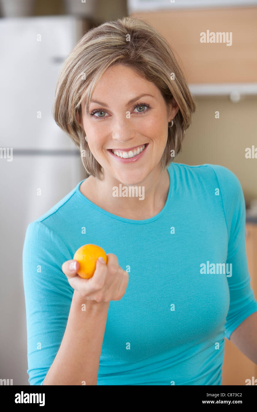 Woman holding Orange Stock Photo - Alamy