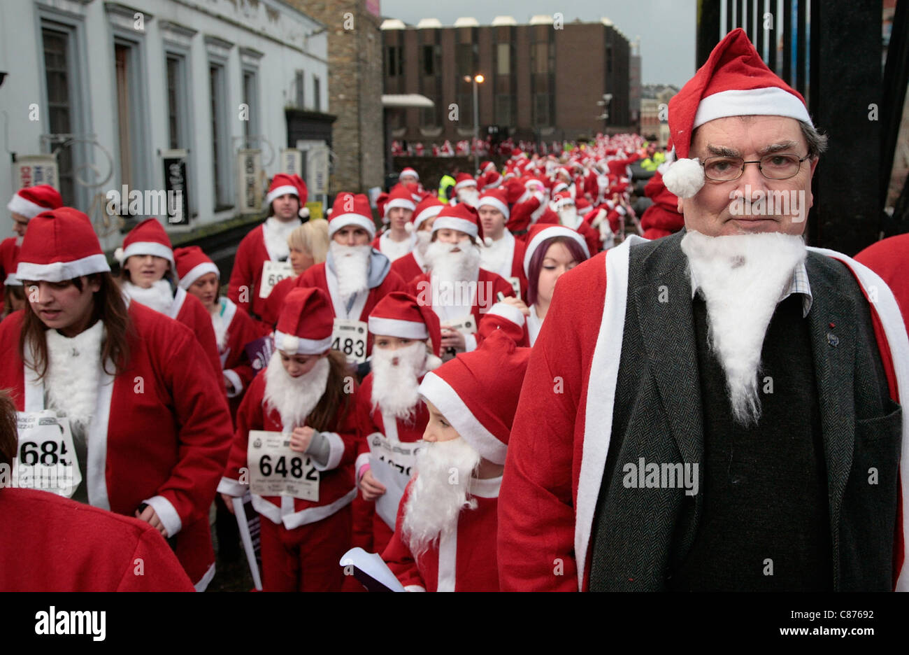 DERRY, UNITED KINGDOM - DECEMBER 09: John Hume. Over 10000 people dressed as santa claus attempt the Guinness World Record in Derry Northern Ireland on Derrys Walls Stock Photo