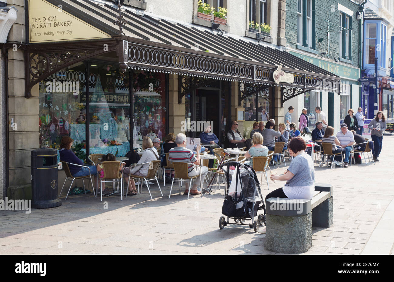 People sitting outside a tea room in Keswick, Lake District Stock Photo
