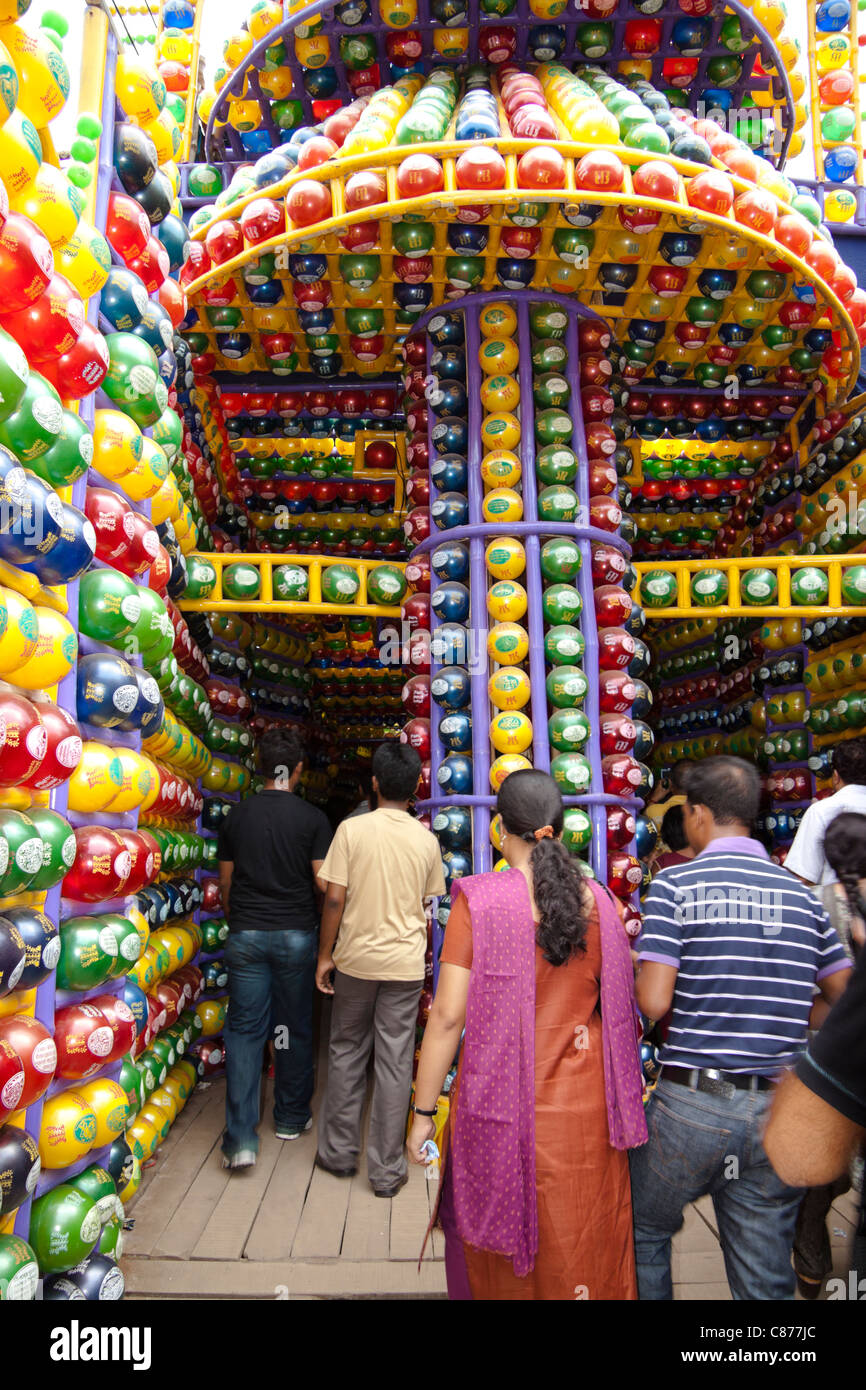 Devotees at 'Karbagan Durga Puja pandal' made of coloured plastic balls ...