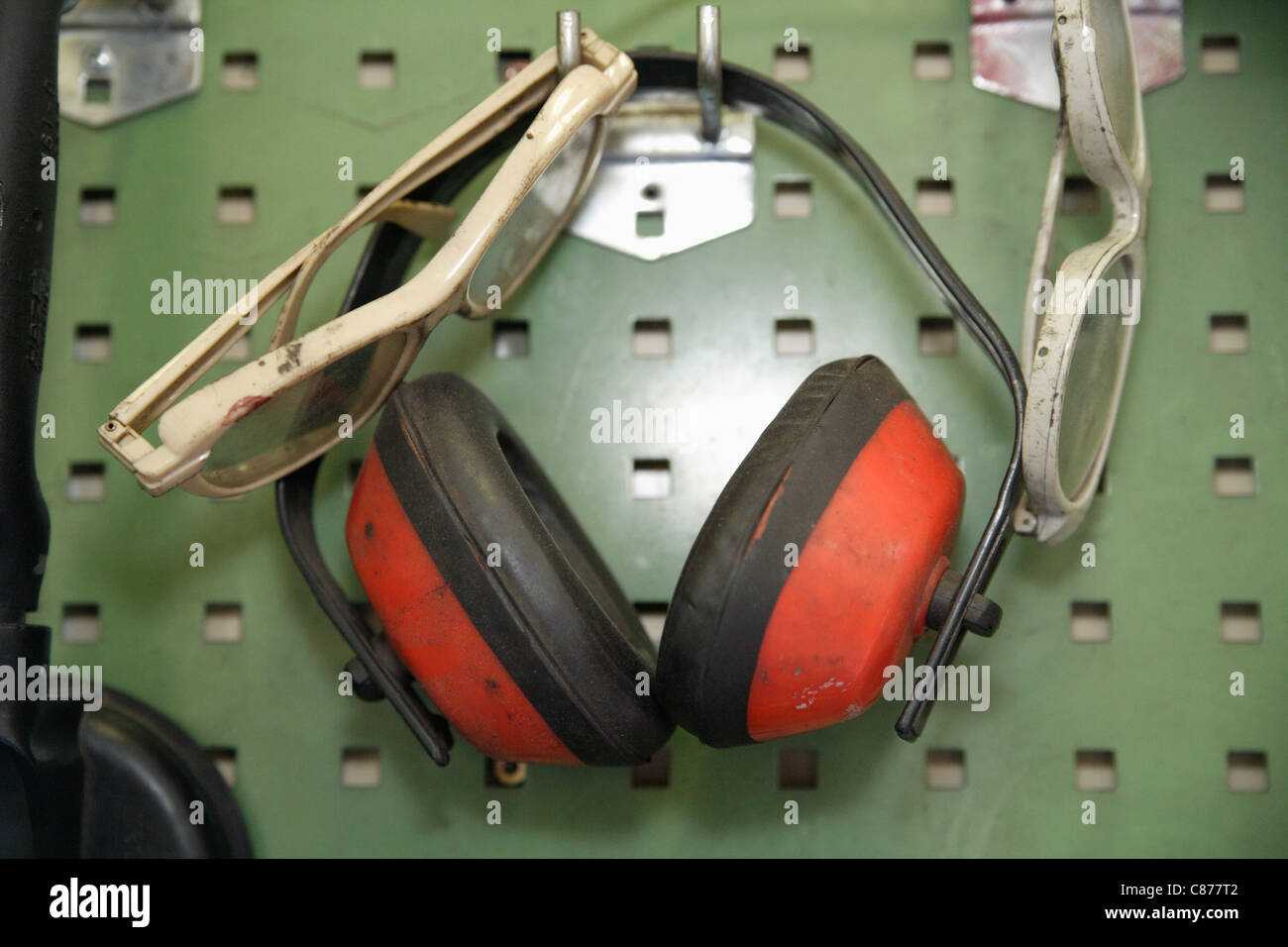 Germany, Ebenhausen, Close up of safety glasses and ear protectors on pegboard in repair garage Stock Photo