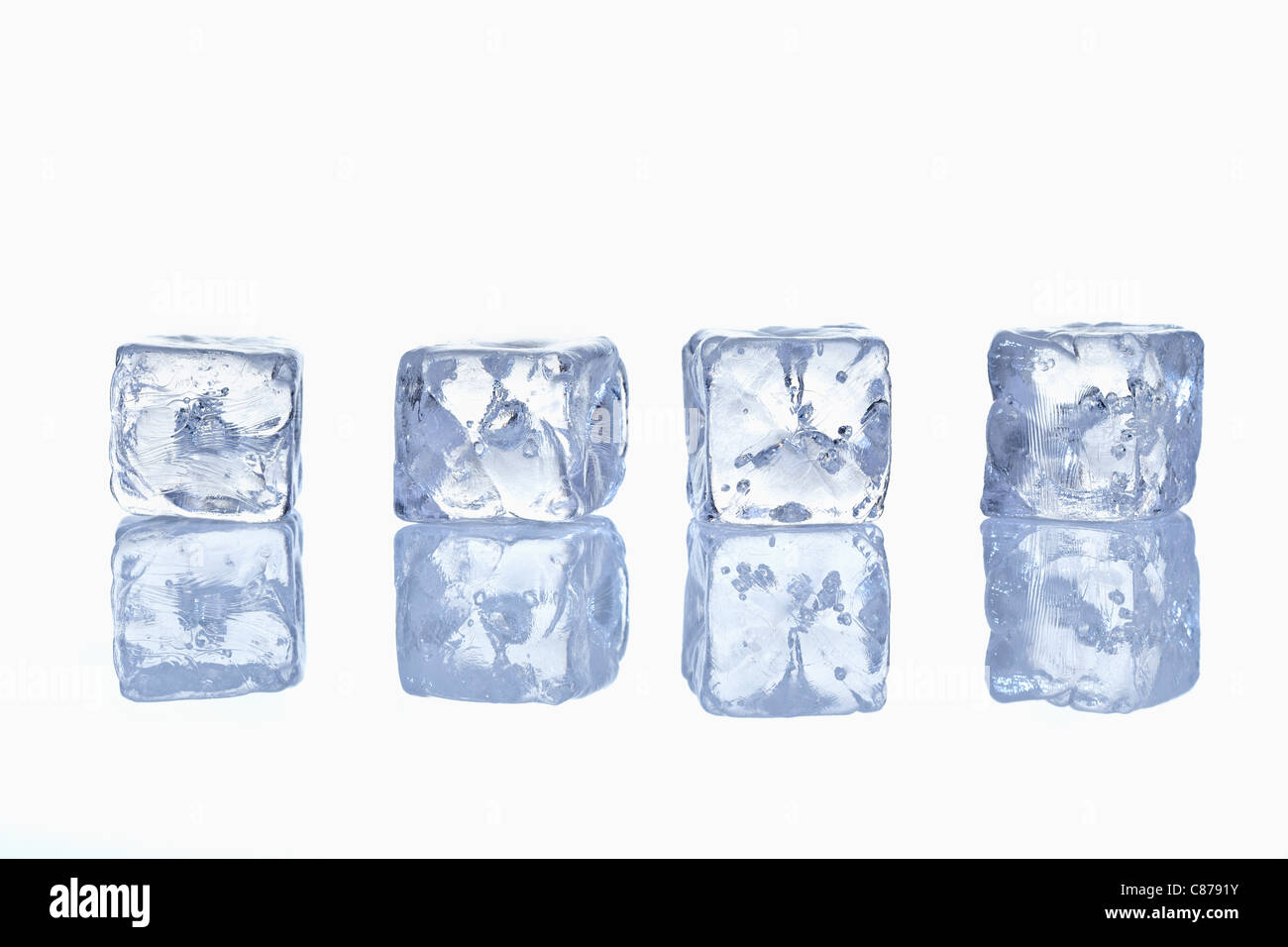 Four ice cubes in row with reflection on glass Stock Photo - Alamy