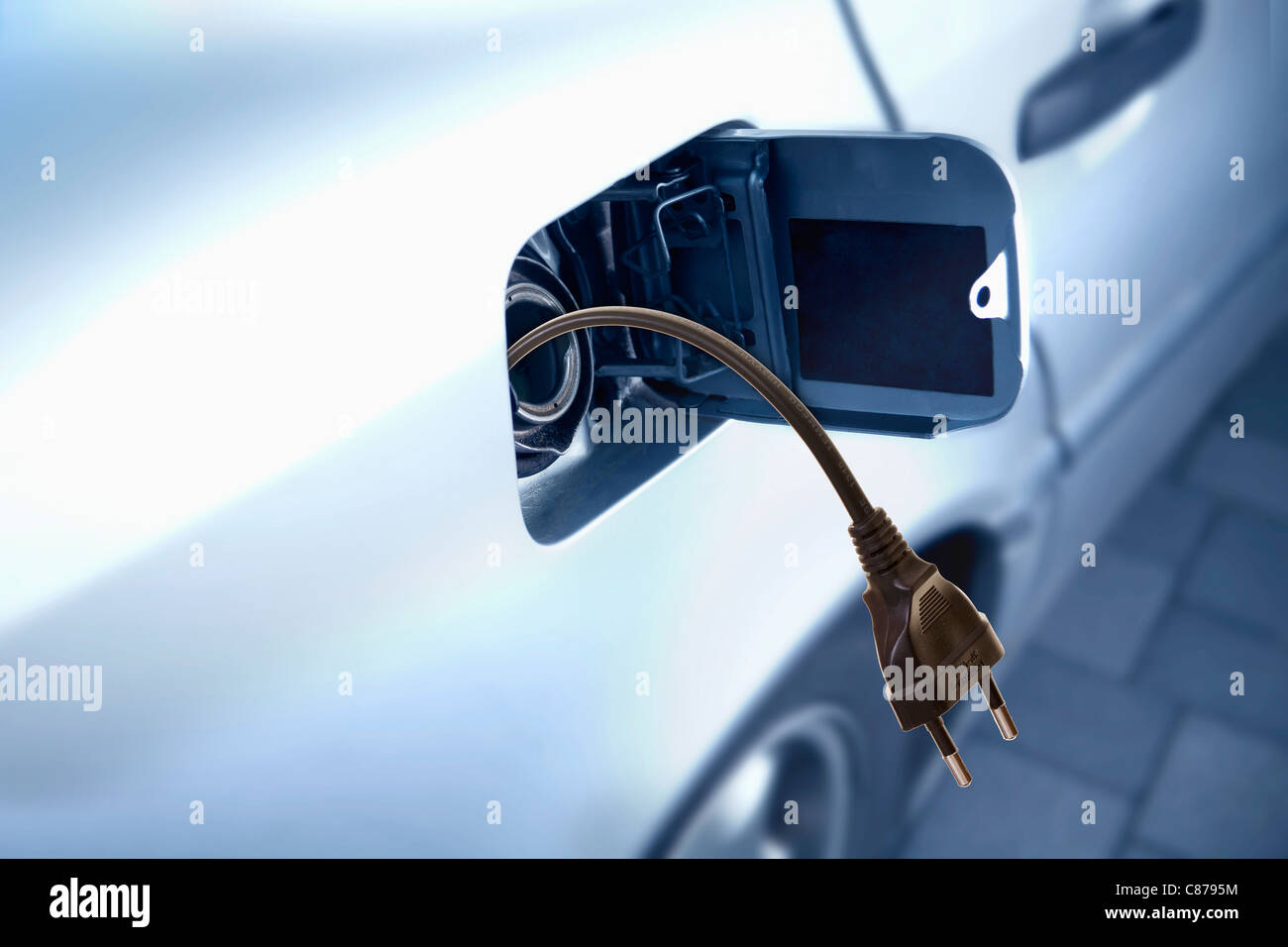 Germany, Close up of car fuel storage tank with power cord Stock Photo