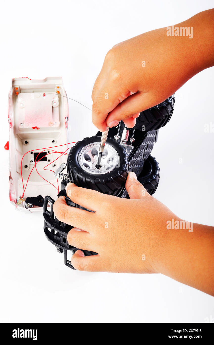 Repairs car toy on white Stock Photo Alamy
