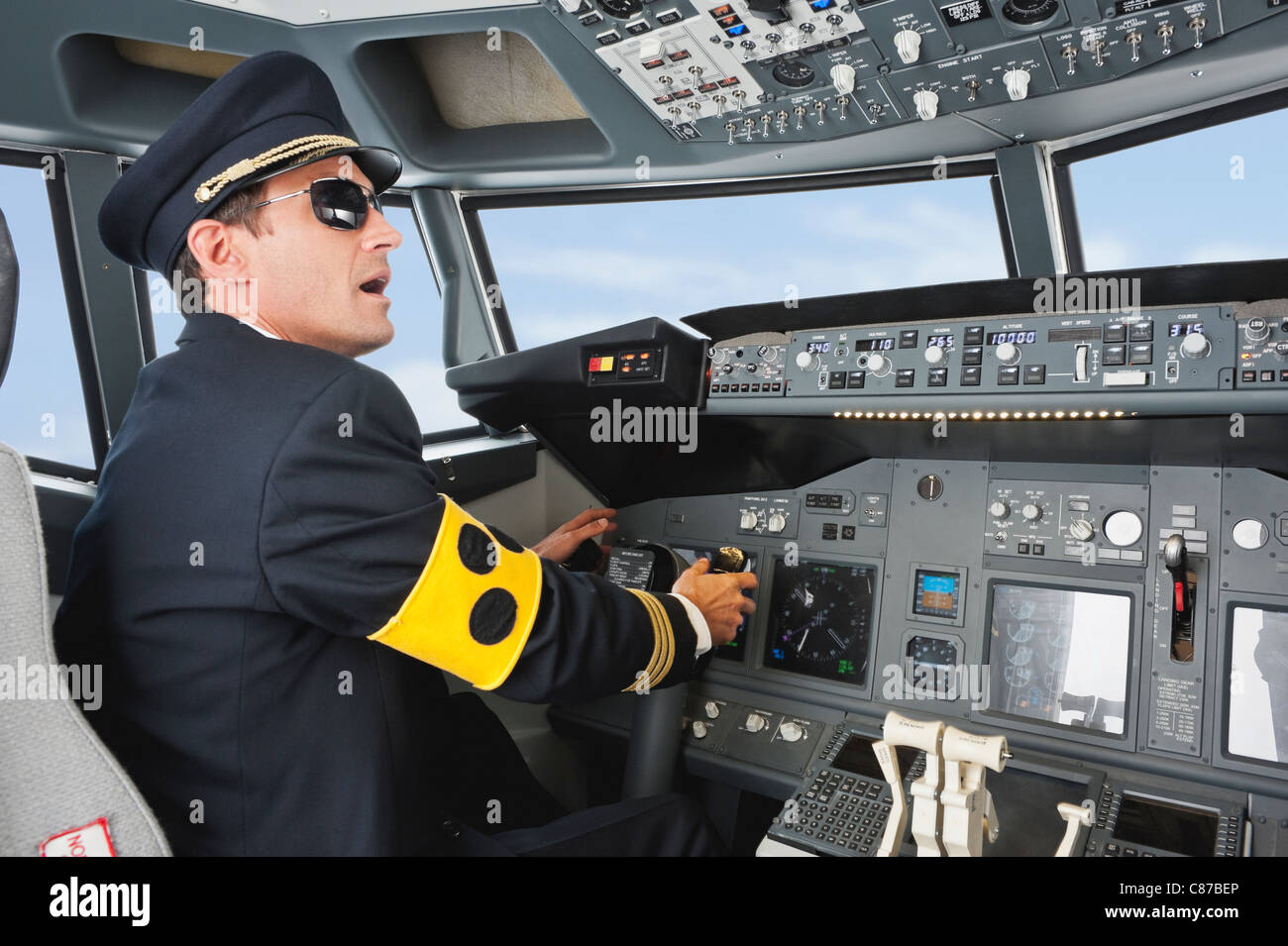 Germany, Bavaria, Munich, Pilot with armlet for blind piloting aeroplane from airplane cockpit