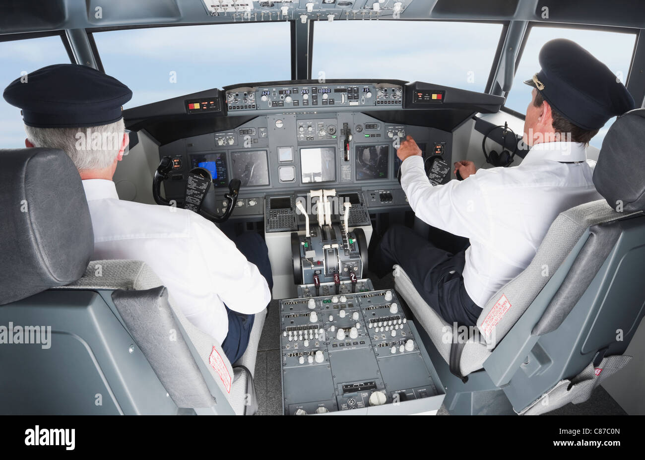 Germany, Bavaria, Munich, Pilot and co-pilot piloting aeroplane from airplane cockpit Stock Photo