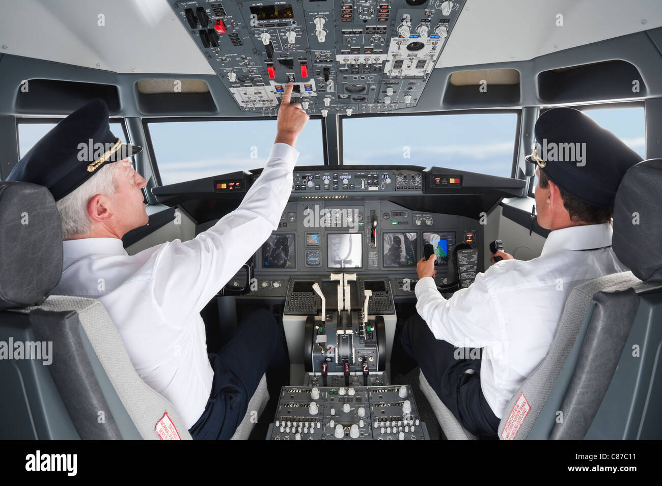 Germany, Bavaria, Munich, Pilot and co-pilot piloting aeroplane from airplane cockpit Stock Photo