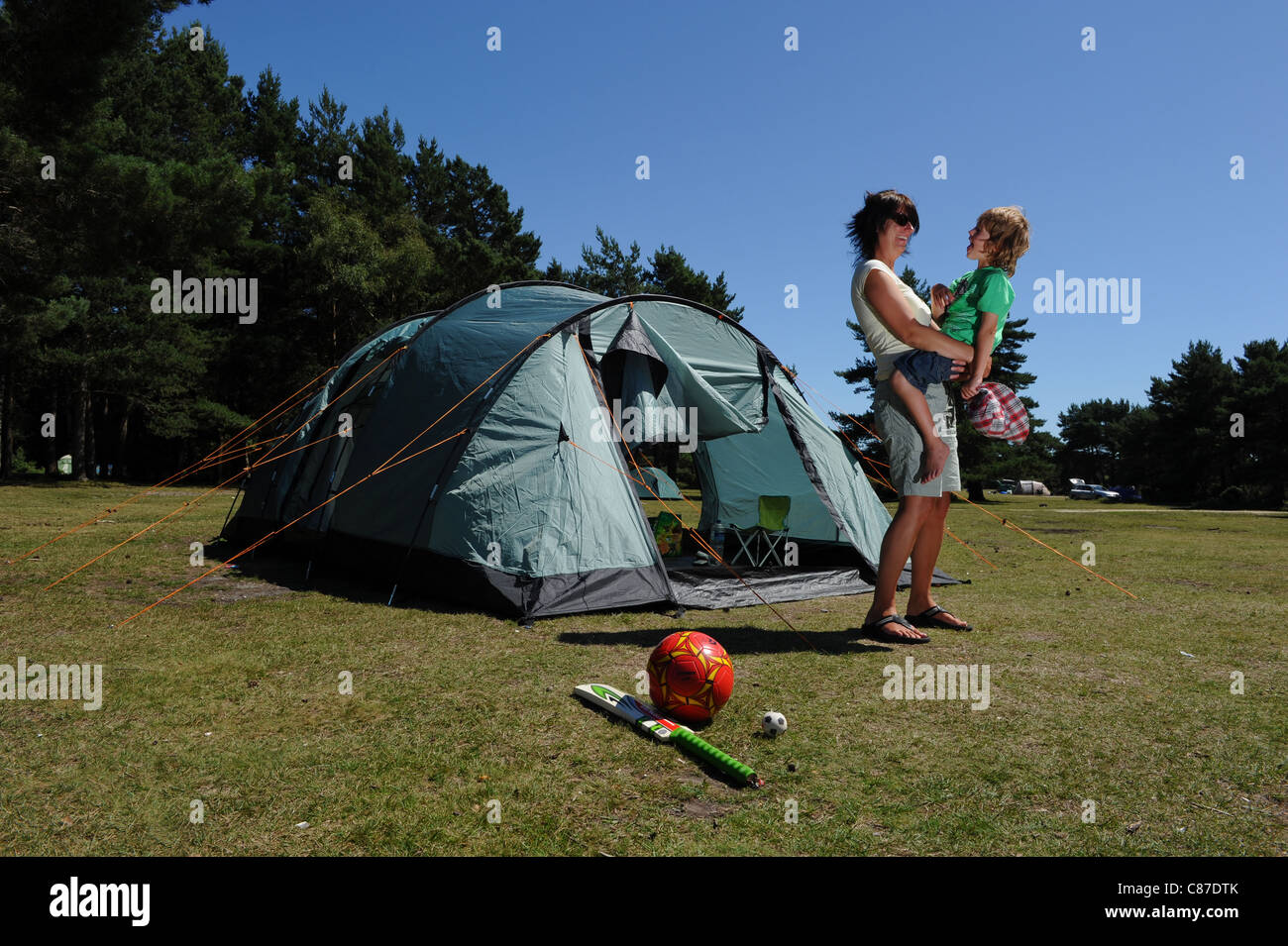 a mother and son having fun on a camping vacation holiday in the summer Stock Photo