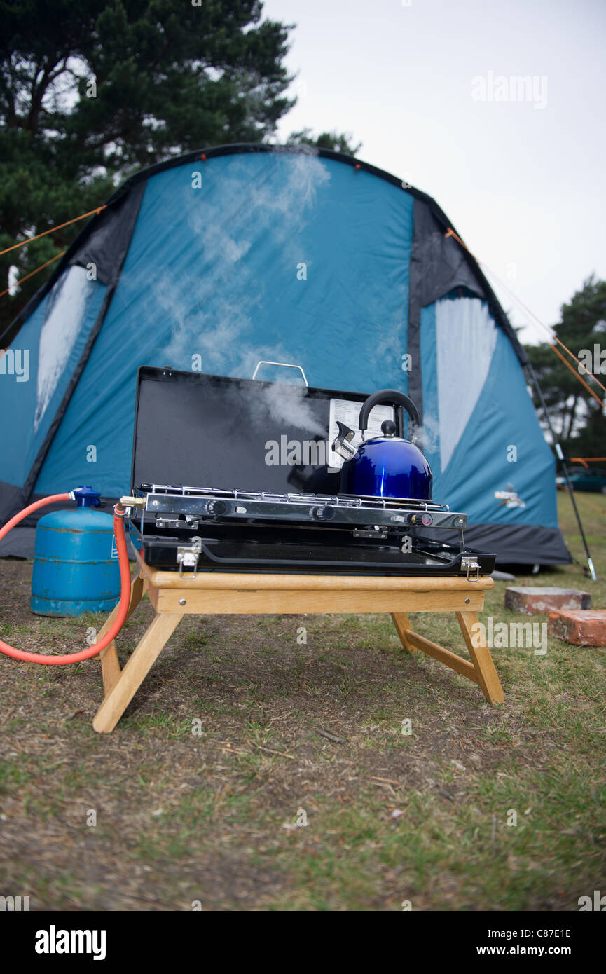 Gas camping stove boiling kettle outside tent Stock Photo Alamy