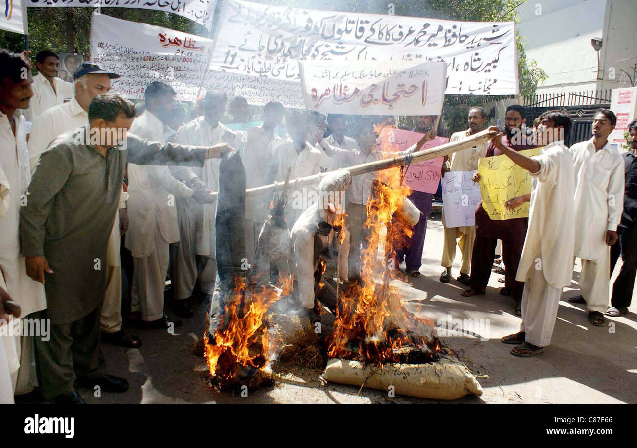 Residents of Mehar Ali Shah Housing Society burn  effigy as they are protesting against builders mafia in Hyderabad on Friday, October 14, 2011. Stock Photo