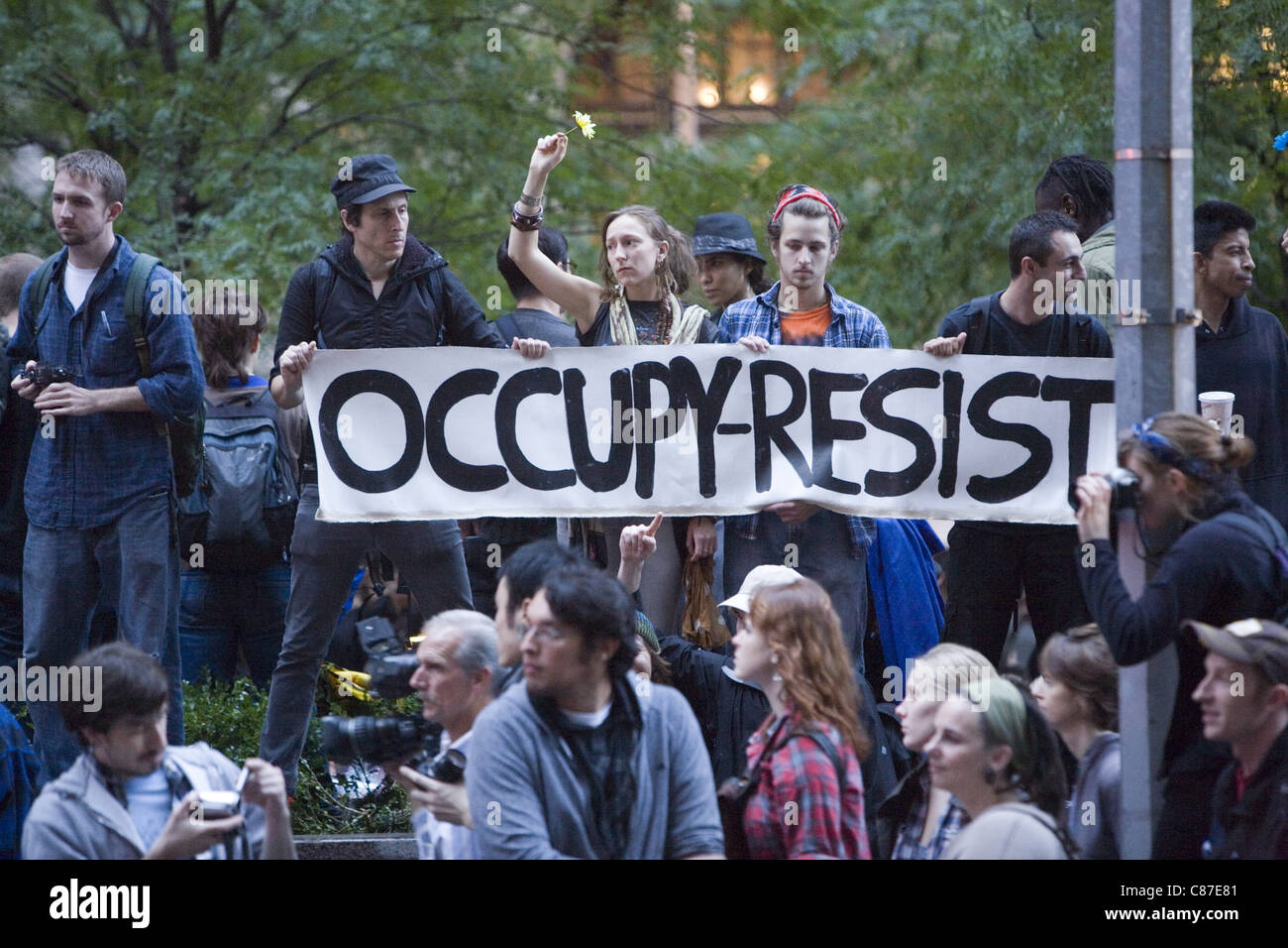 Occupy Wall Street activists hold their ground in the early morning of Oct. 14th when New York City Mayor threatened to remove them. them Stock Photo