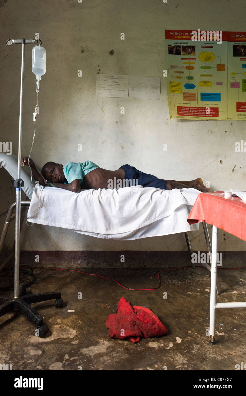 Patient with an intravenous drip tubing attached in poorly equipped dispensary, Quelimane Mozambique Stock Photo