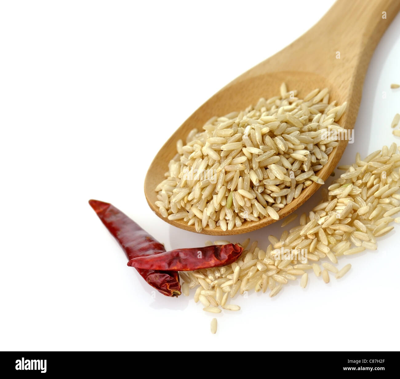 Natural brown rice in a wooden spoon Stock Photo