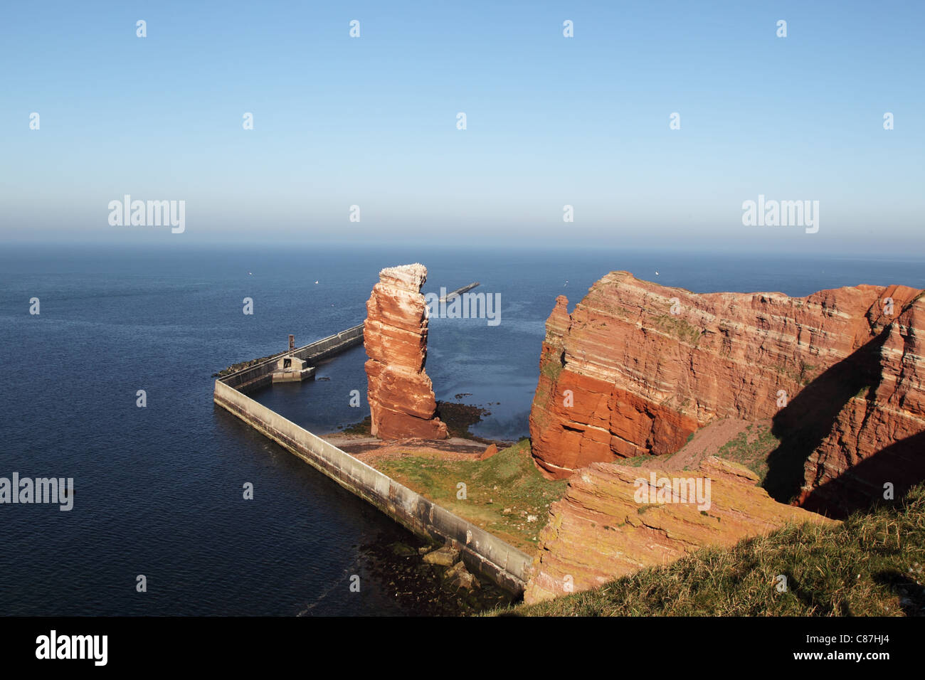 Cliff line of Heligoland with the Tall Anna, the landmark of Heligoland. Stock Photo