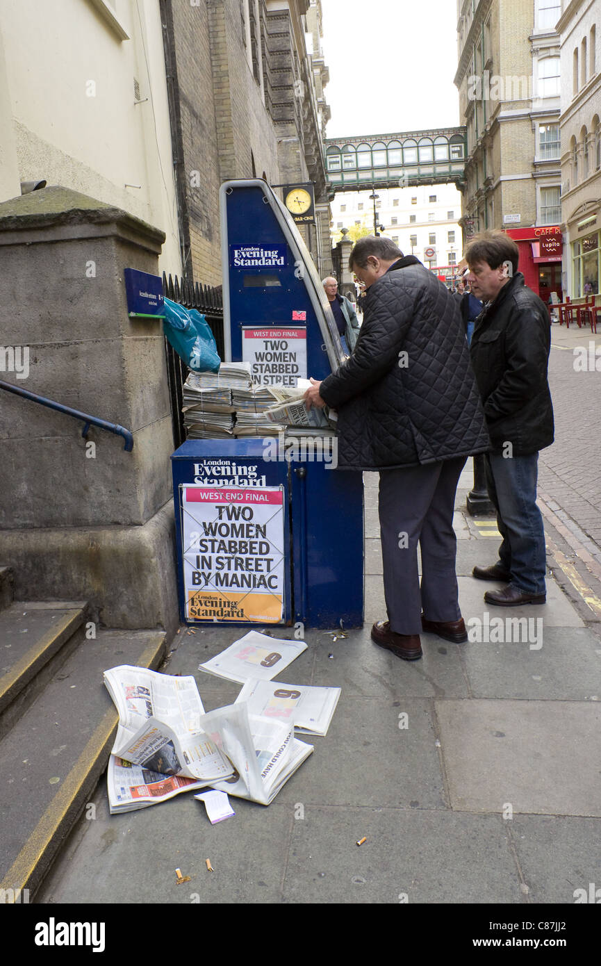 London Eevening Standard sale stand near Charing Cross, papers flying off in the wind Stock Photo