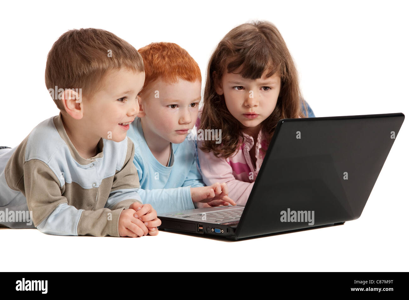 Three happy kids learning on notebook computer together. Isolated on ...