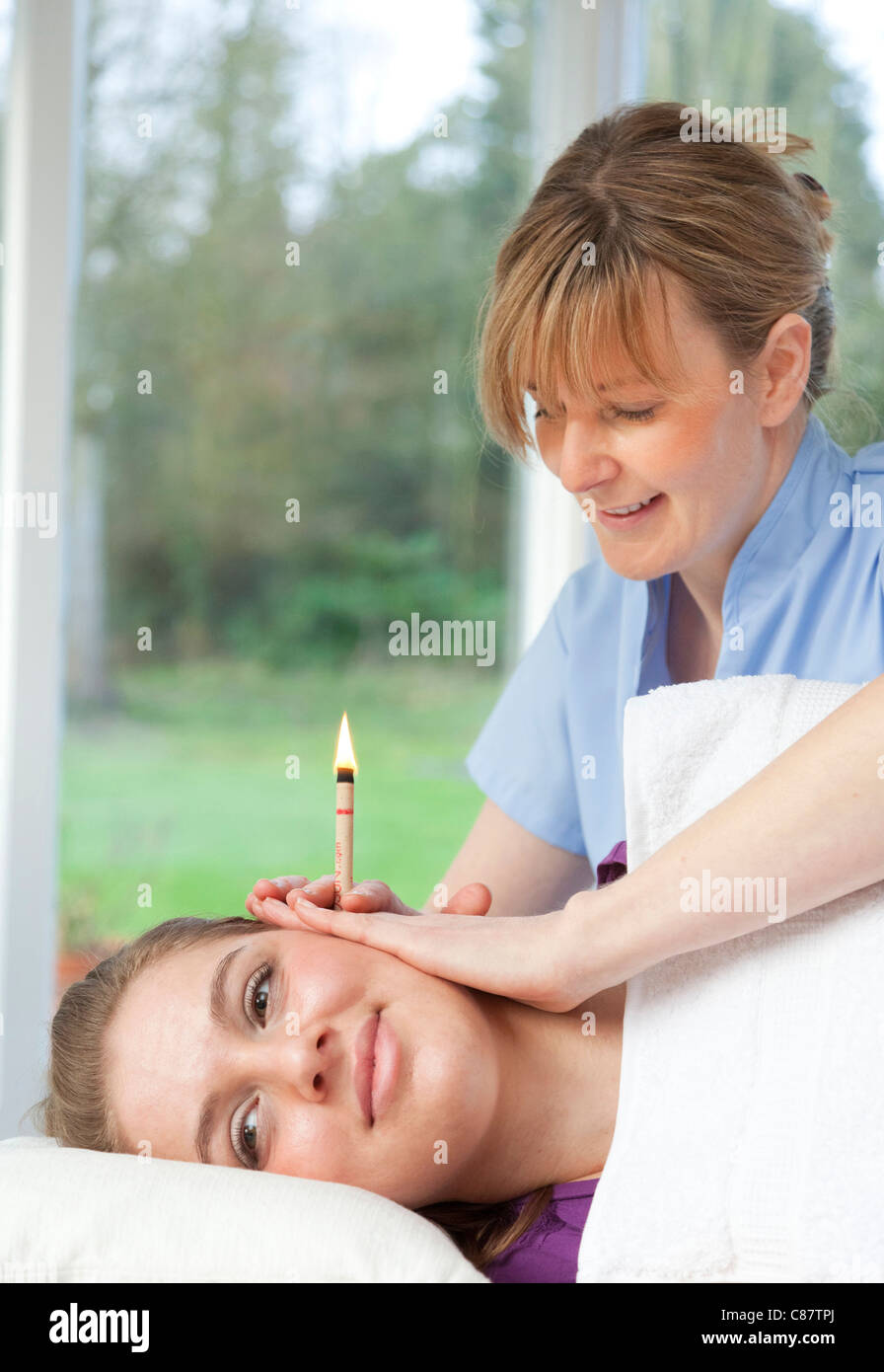 ear candling treatment in the UK Stock Photo Alamy