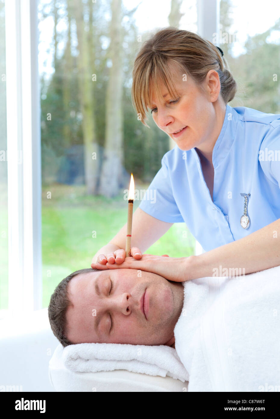 ear candling treatment in the UK Stock Photo Alamy