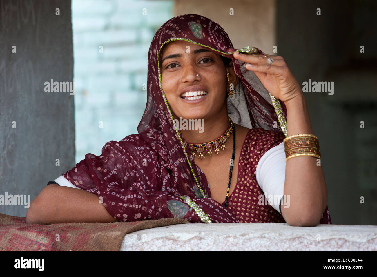 Pretty young Indian woman at home in Narlai village in Rajasthan, Northern India Stock Photo