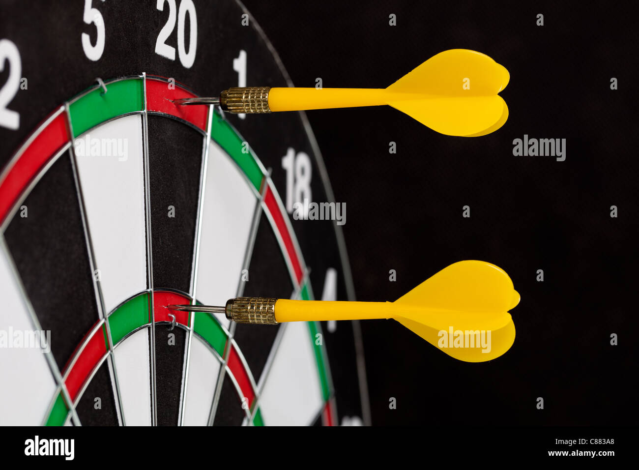 Three darts hitting the bullseye on a dartboard Stock Photo Alamy