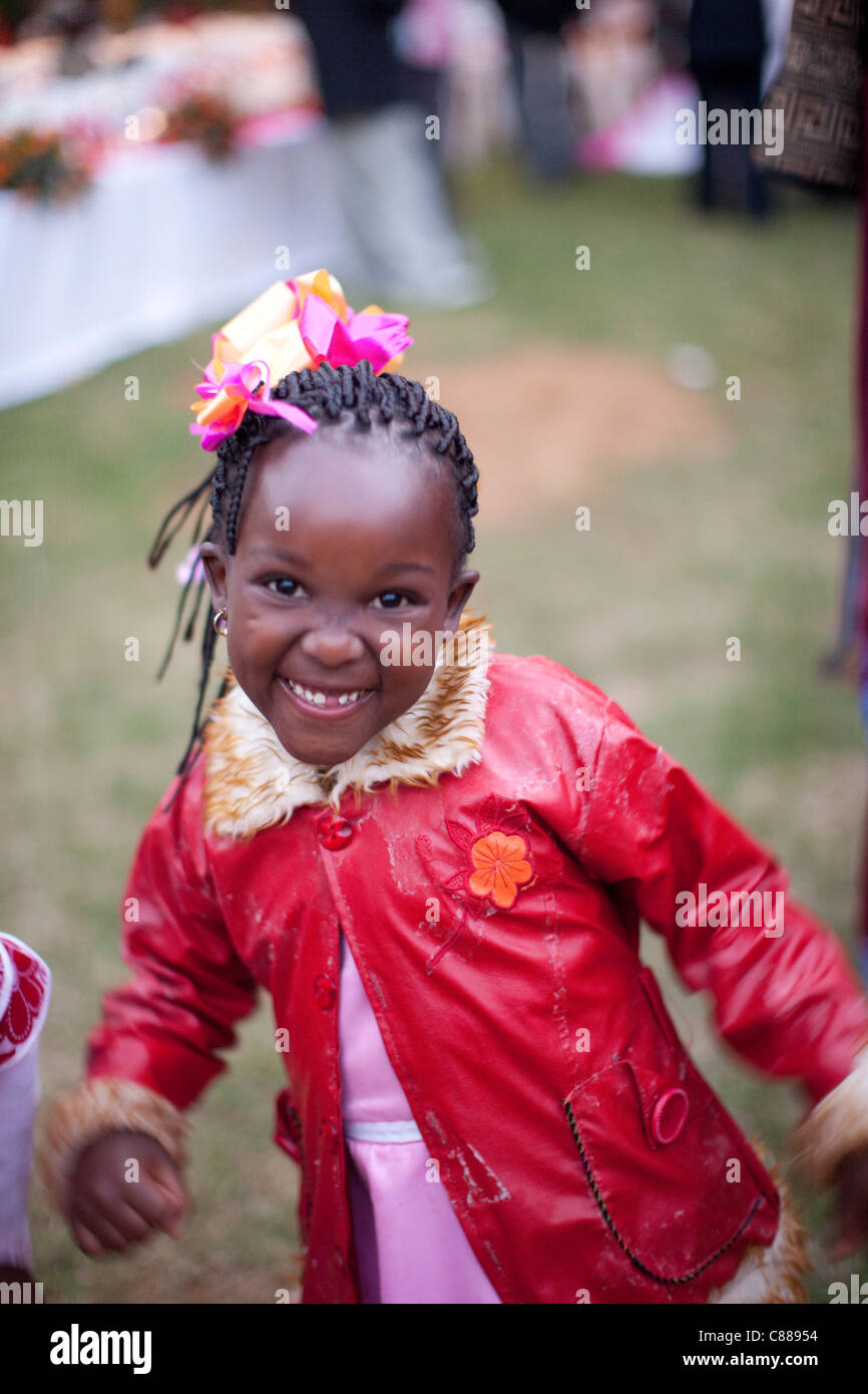 A child celebrates at a wedding outside of Arusha, Tanzania, East Africa. Stock Photo