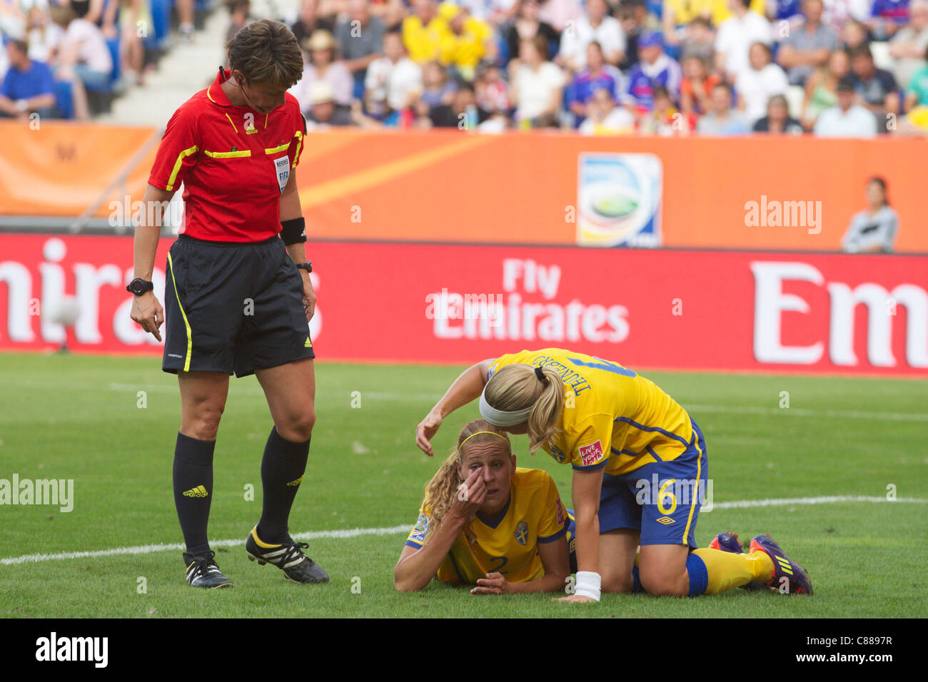 Charlotte Rohlin of Sweden adjusts her contact lens with help from teammate Sara Thunebro during the World Cup 3rd place match. Stock Photo