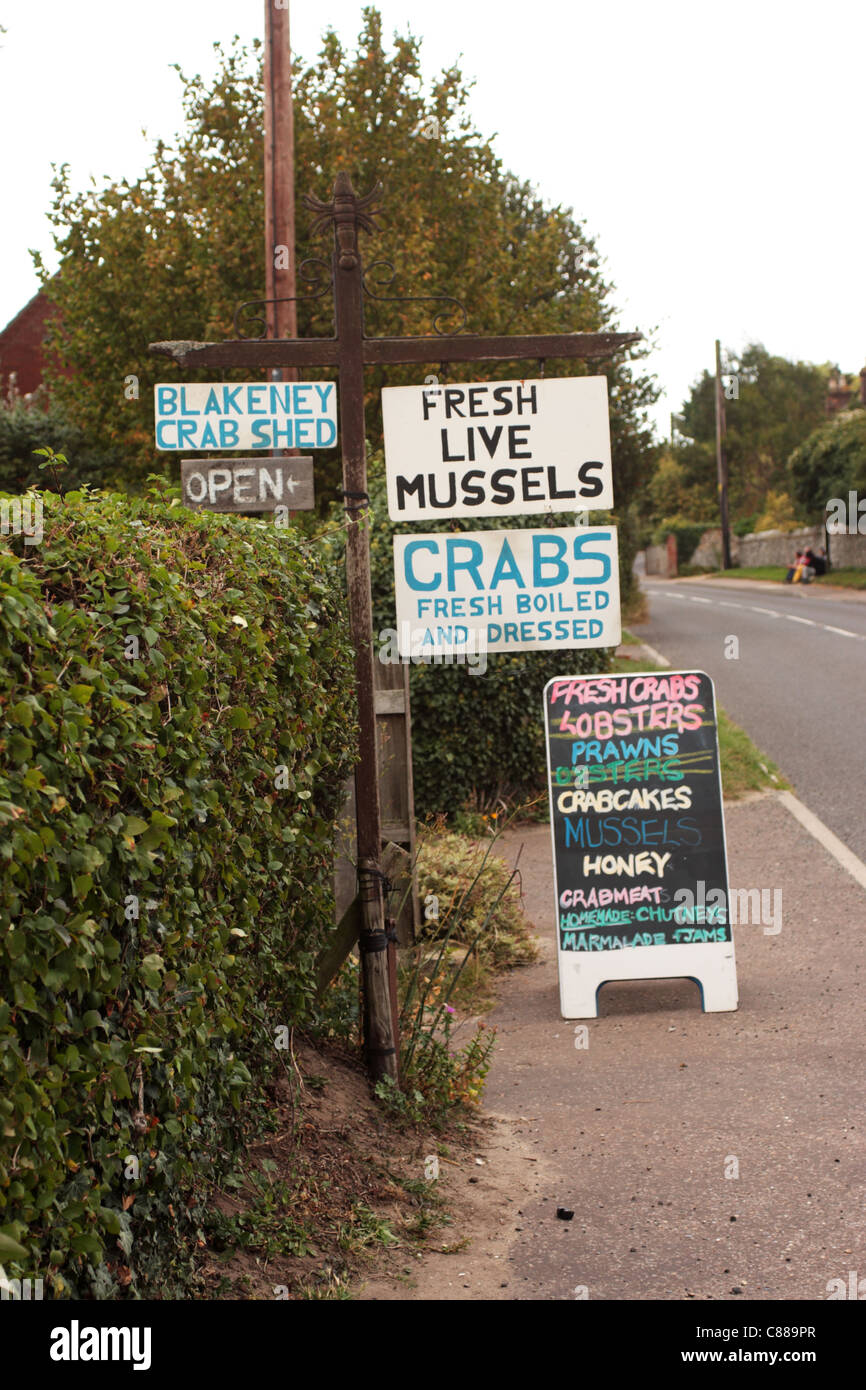 Roadside signs advertising fresh shellfish and local food produce Blakeney Norfolk UK Stock Photo