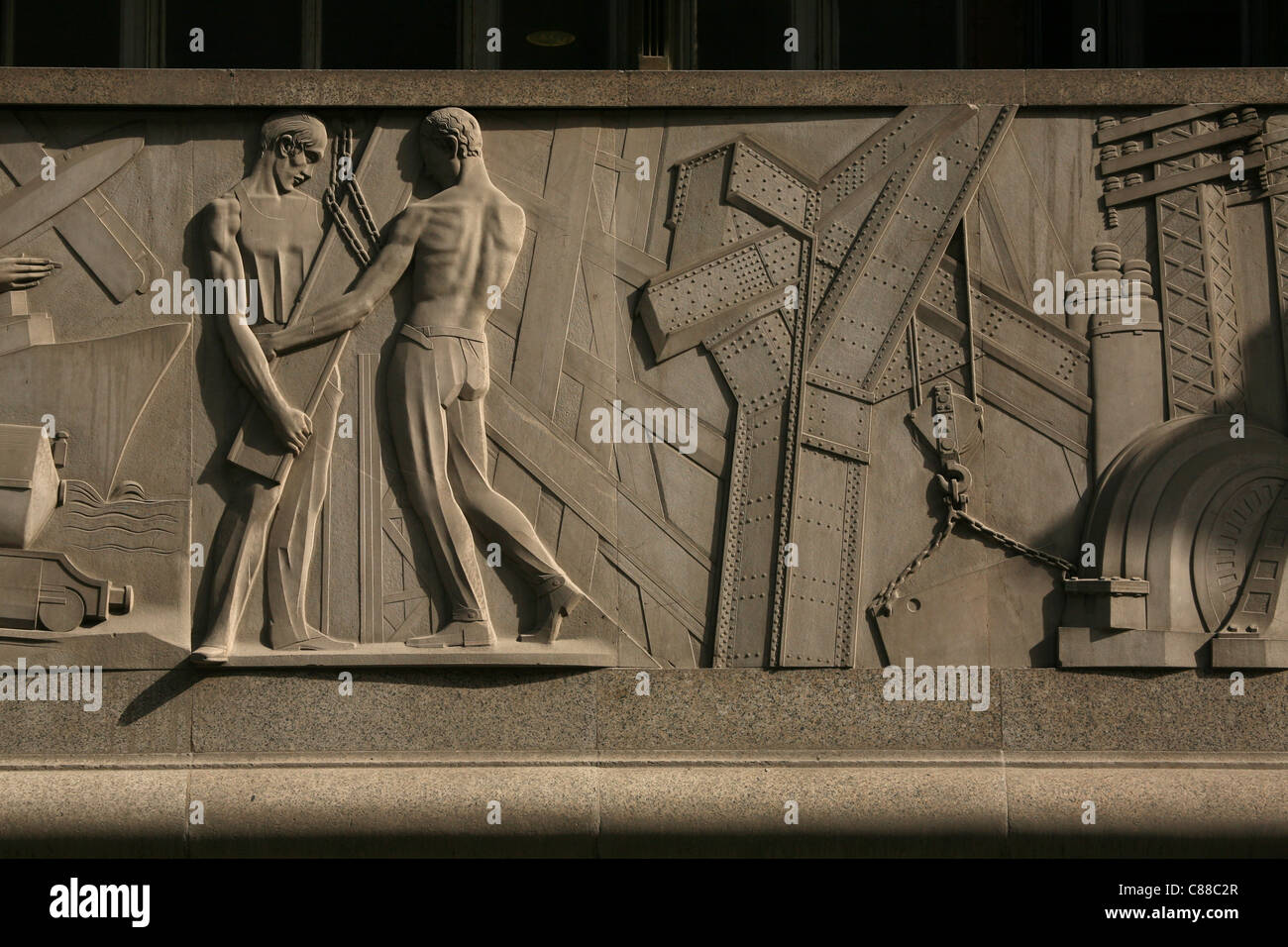 Allegory of economy, commerce and industry. Relief from the Franco Era on the bank building on Calle Alcala in Madrid, Spain. Stock Photo