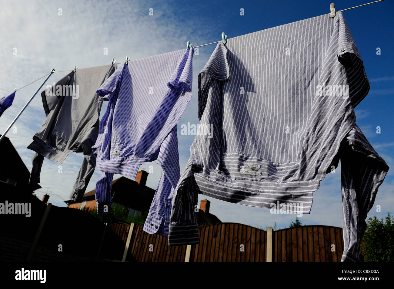 shirts hanging on a washing line england uk Stock Photo