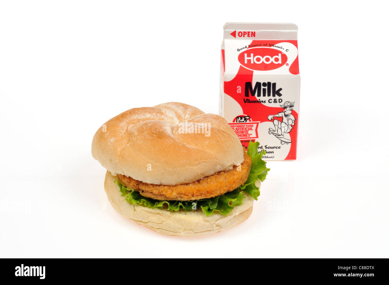 Chicken burger with lettuce on bread roll with a carton of milk on white background cutout. USA Stock Photo