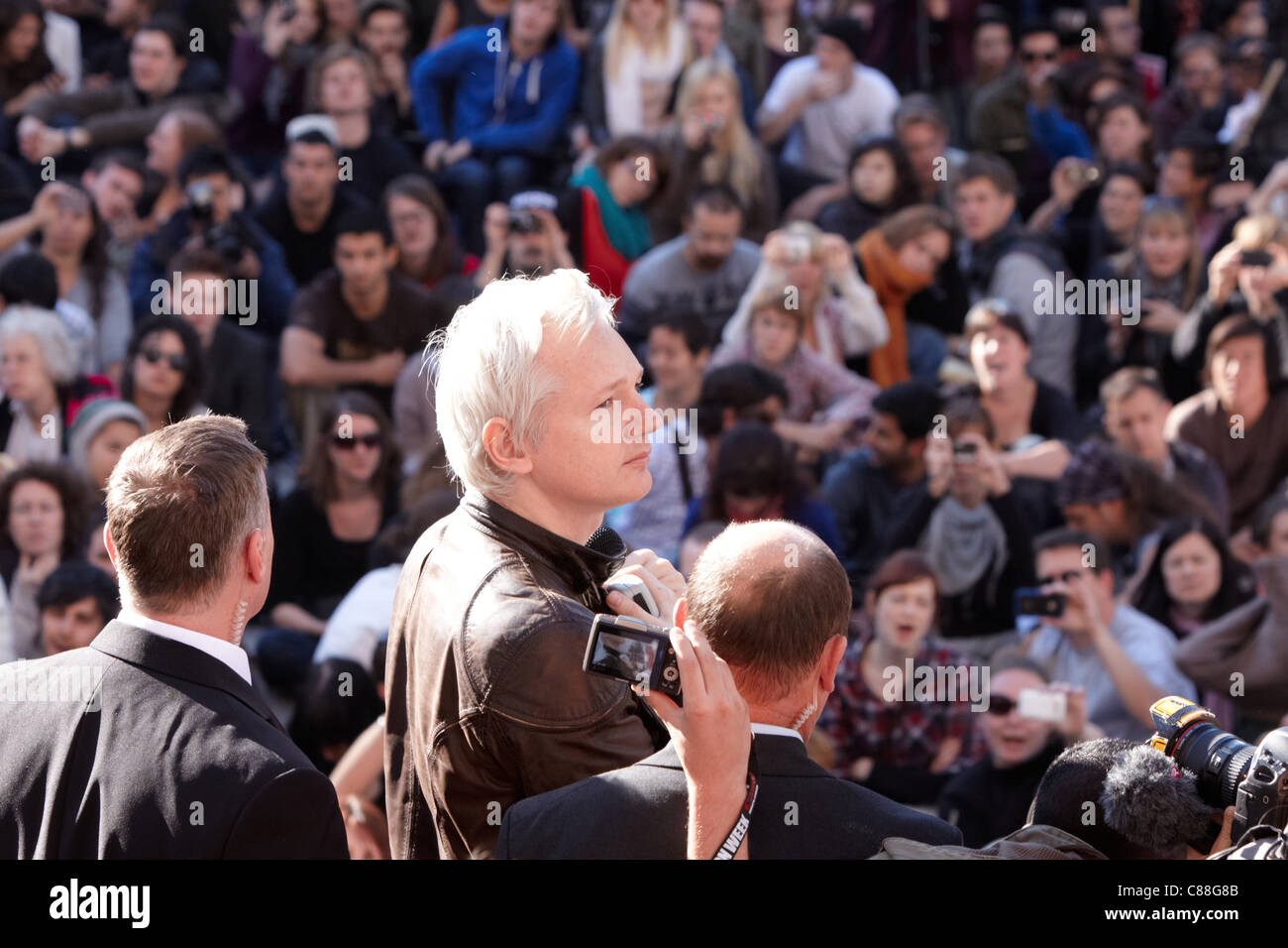 Julian Assange (C) addresses the crowd from the steps of St Pauls Cathedral as part of the Occupy London Stock Exchange protest Stock Photo