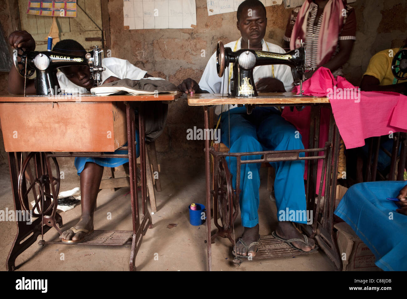 Youth learn tailoring at a vocational training workshop in Amuria, Uganda, East Africa. Stock Photo