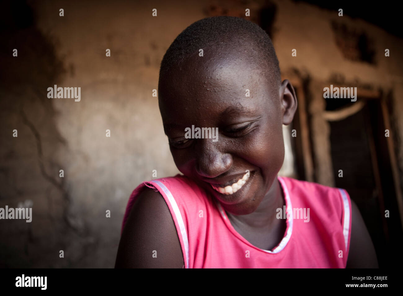 Shy teenage girl laughing - Amuria, Uganda, East Africa. Stock Photo