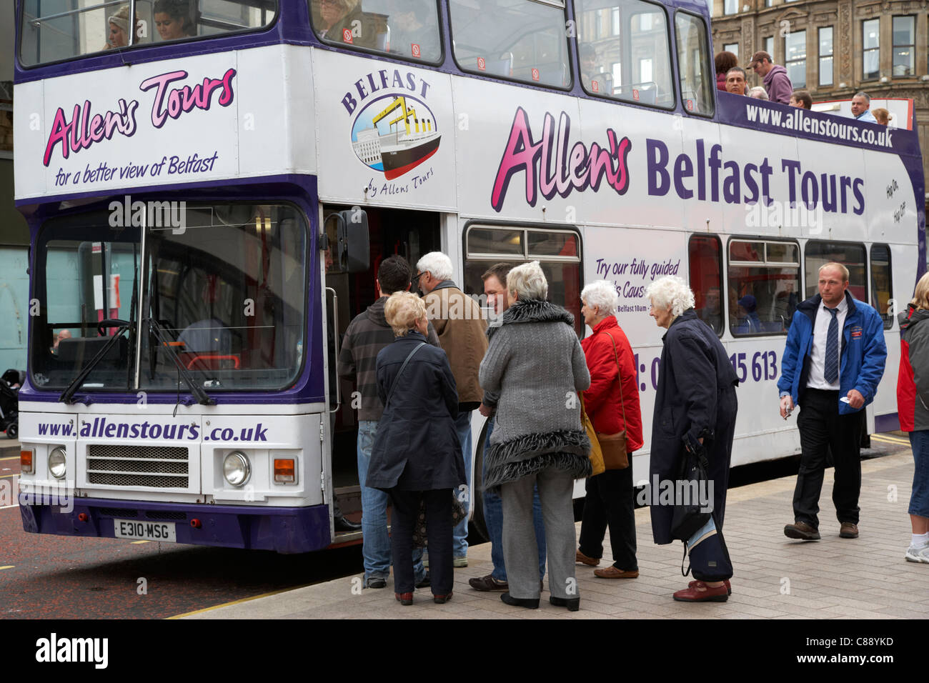 tourists boarding double deck guided tour bus belfast city centre northern ireland uk Stock Photo