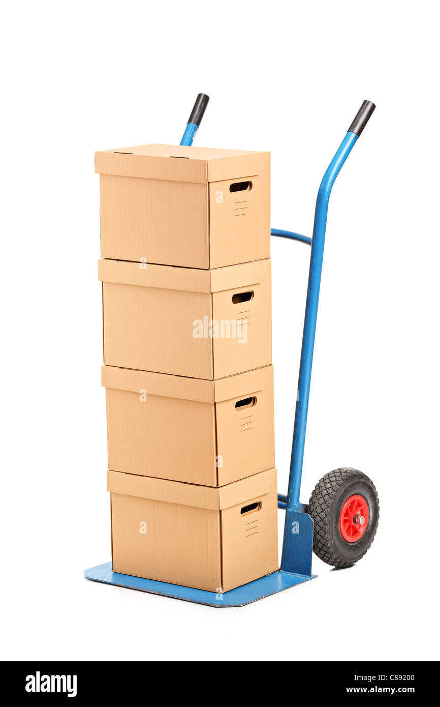 A studio shot of a hand truck with many boxes on it Stock Photo