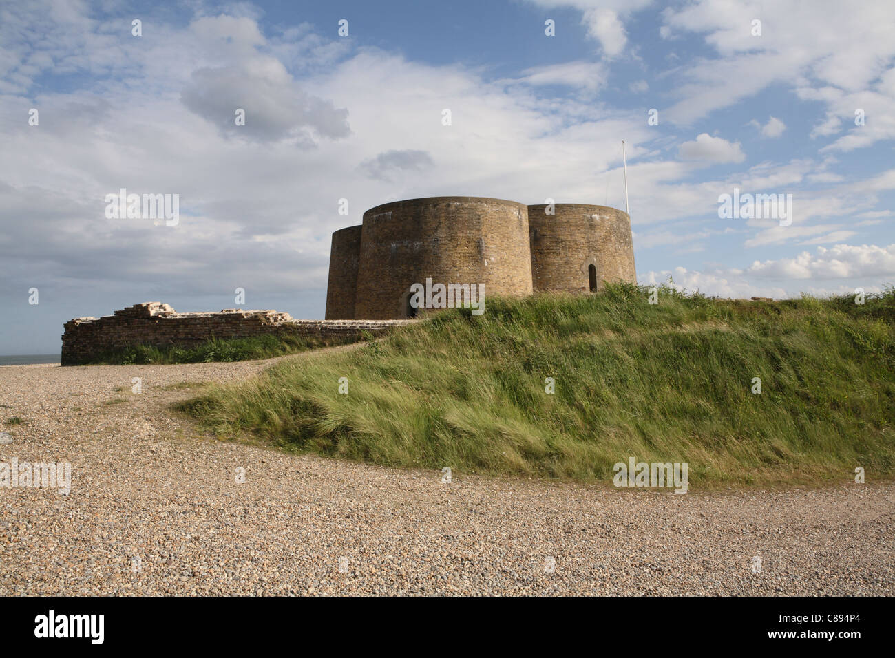 Martello Tower, Slaughden, Aldeburgh, Suffolk, now rented as a holiday let by the Landmark Trust. Evening sunshine and blue sky. Stock Photo