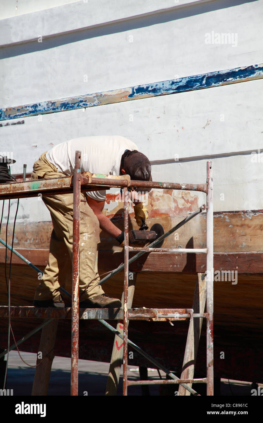 Seaman painting a boat´s hull Stock Photo Alamy
