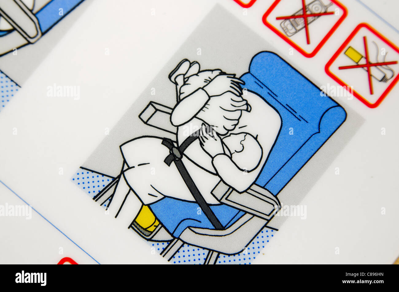Closeup of an airline safety card showing the "Brace" position Stock